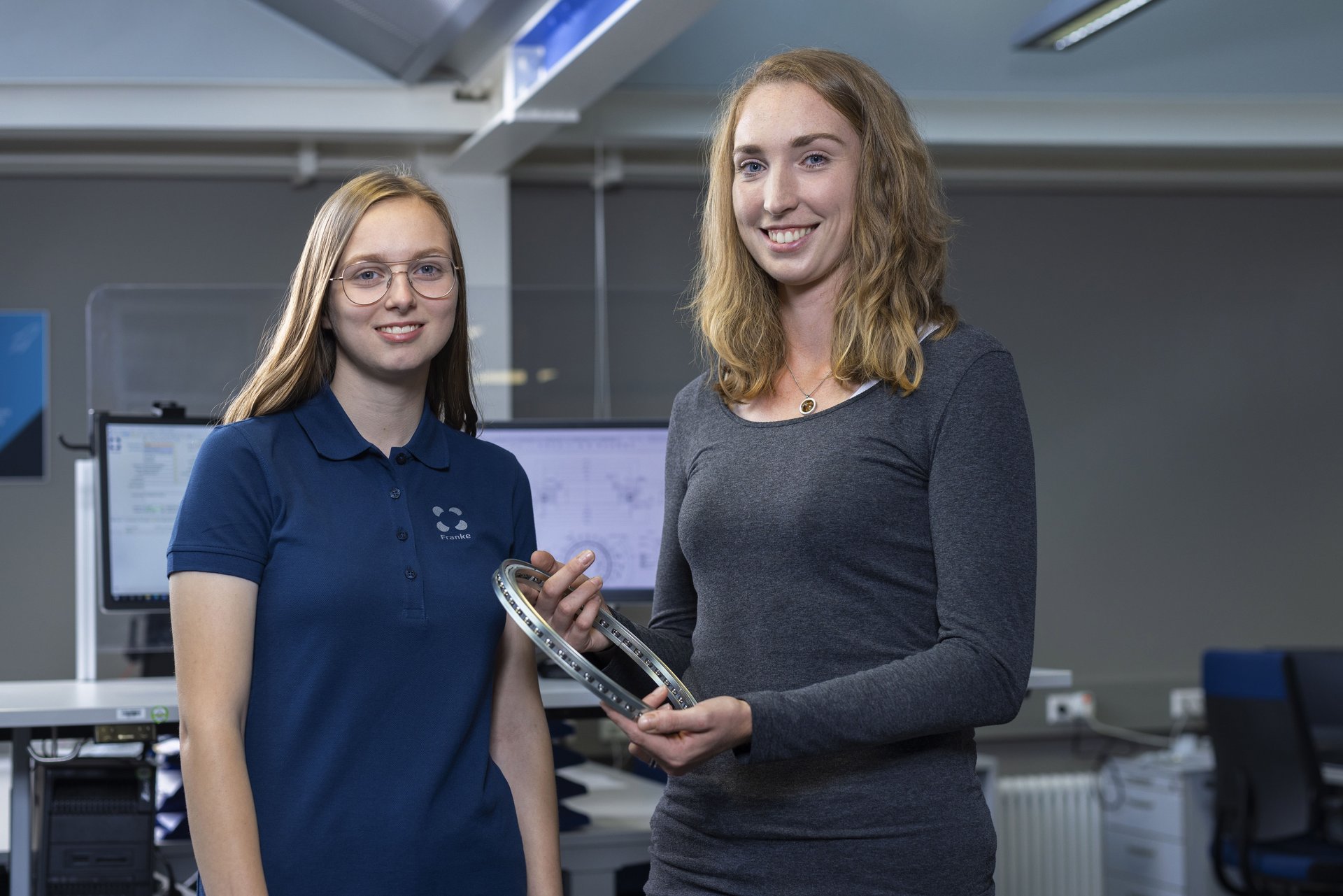 Apprentices at Franke holding a wire race bearing